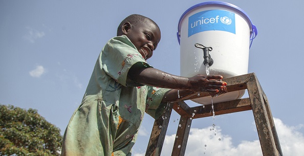 On 13 August 2018, Jean Marie Bofio, UNICEF’s WASH Officer, talks with a girl as she washes her hands in order to prevent the spread of Ebola near Mangina, North Kivu, the Democratic Republic of the Congo (DRC). “Children and women are among the first victims of the Ebola outbreak in the country. But there is hope and everything is done to stop Ebola. Water and sanitation are critical in this fight because hygiene is the best way to prevent the spread of the this deadly disease,” says Jean Marie Bofio.