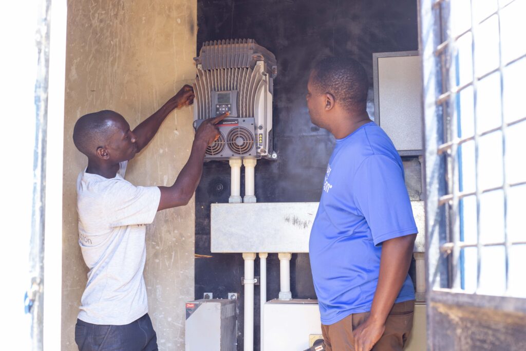 Yosia Kulanga together with the local system operatore that he has trained for system operation and maintenance. Photo: Water Mission