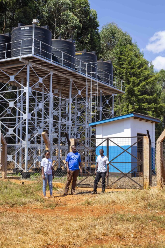 Yosia Kulanga and colleagues in front of the tank structure in X village. Photo: Water Mission