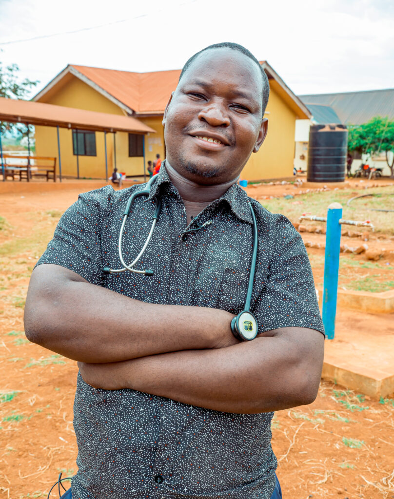 Dr. Boniface Batazari from Kigadye Health Center (Kigoma, Tanzania) in his workplace, showcasing the positive impact of improved healthcare services brought by the WASH facilities.