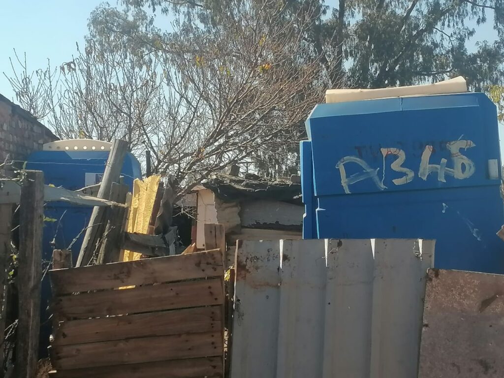 illegal pit latrines in informal settlement.