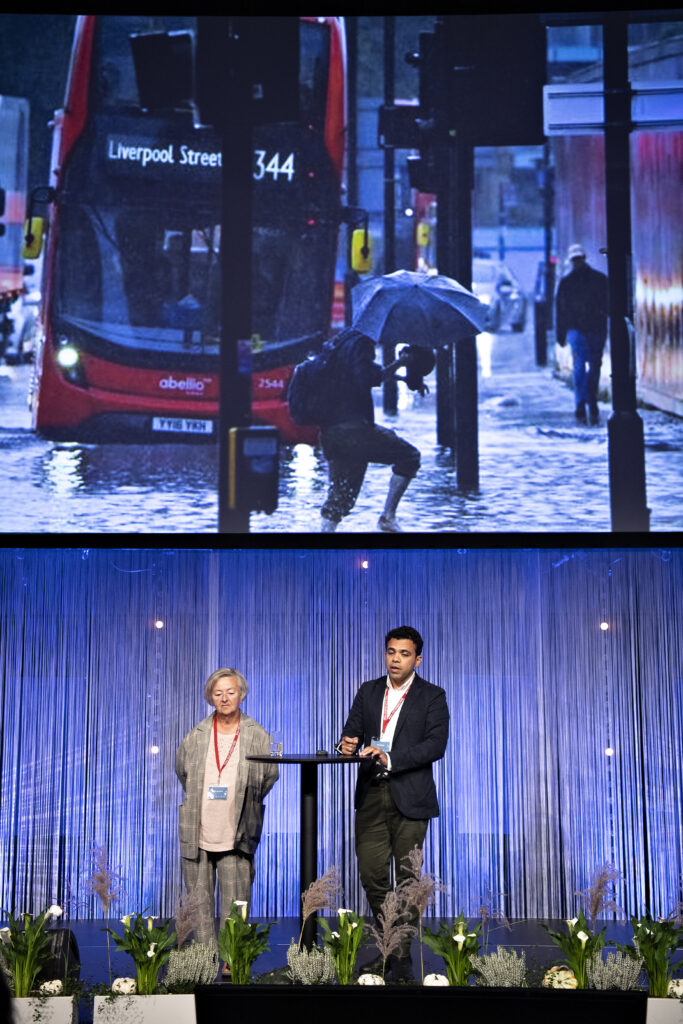 Lykke Leonhardsen and Sachin Bhoite from C40 Cities presenting photo from London, a bus and people up to their knees in water.